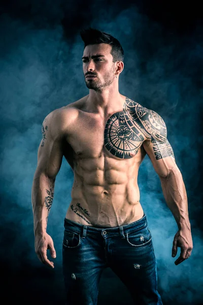 Closeup of muscular male bicep and shoulder with green tattoo body art  branding on young 20's man Stock Photo - Alamy